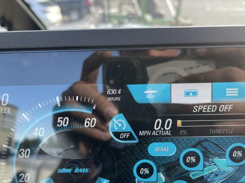 Slide: The Image of Dashboard of a 2017 Malibu 21 VLX boat showing 630.4 hours and speed settings. - 26
