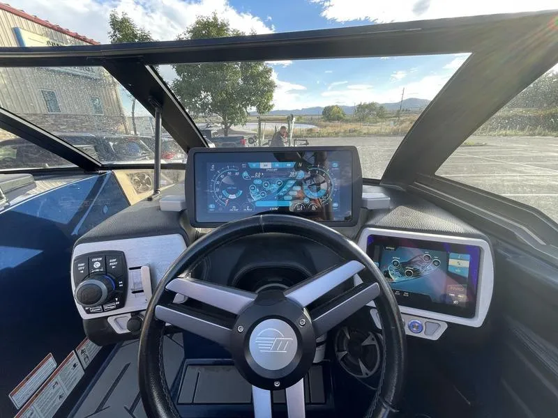 Slide: The Image of 2017 Malibu 21 VLX boat dashboard with modern controls and touchscreen displays. - 27