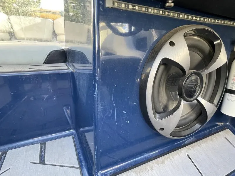 Slide: The Image of 2017 Malibu 21 VLX boat interior with speaker and blue paneling. - 3