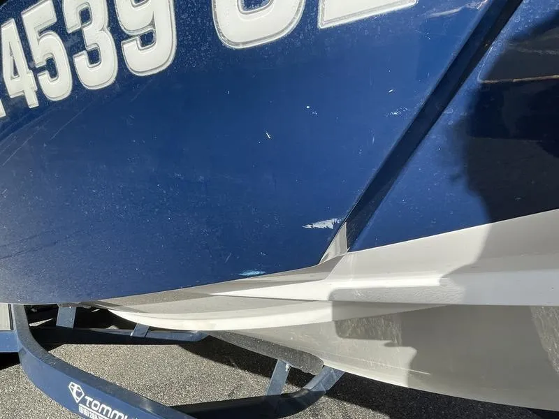 Slide: The Image of Close-up of a 2017 Malibu 21 VLX boat hull with visible registration numbers. - 31