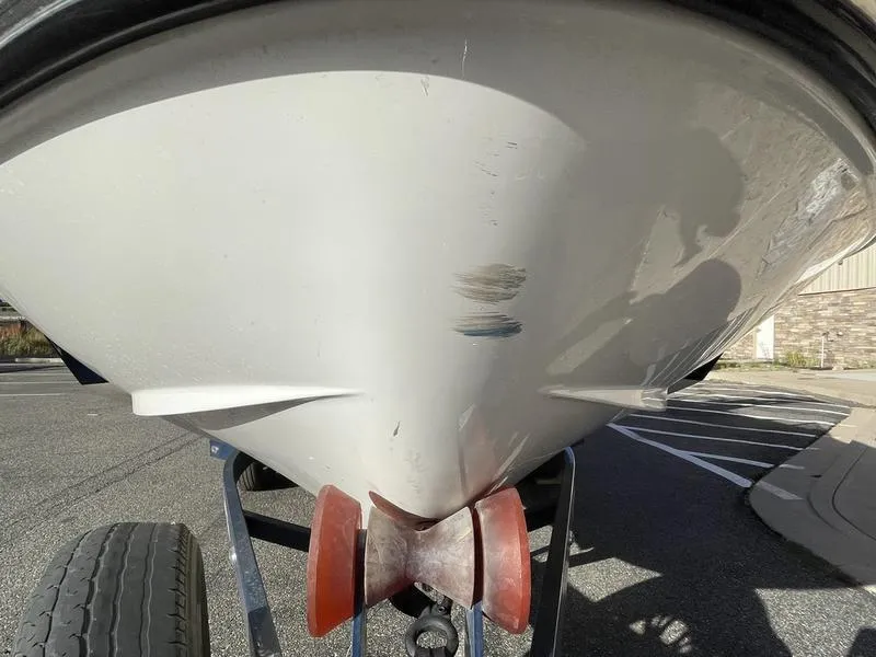 Slide: The Image of 2017 Malibu 21 VLX boat hull with visible scratches on trailer. - 32