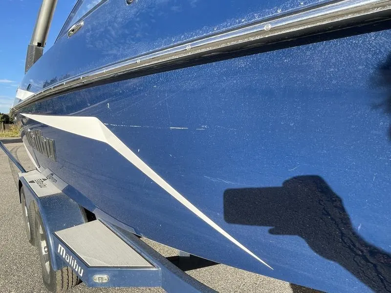 Slide: The Image of Blue 2017 Malibu 21 VLX boat on trailer, side view with shadow. - 34