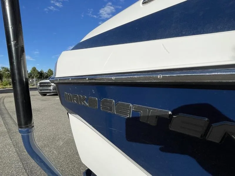 Slide: The Image of Close-up of 2017 Malibu 21 VLX boat with blue and white exterior. - 36