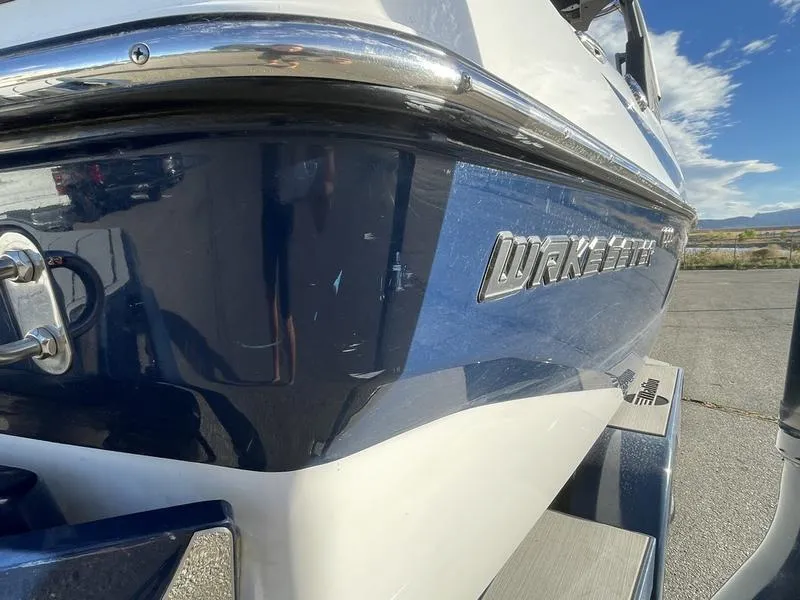 Slide: The Image of 2017 Malibu 21 VLX boat, blue and white exterior, parked outdoors. - 37