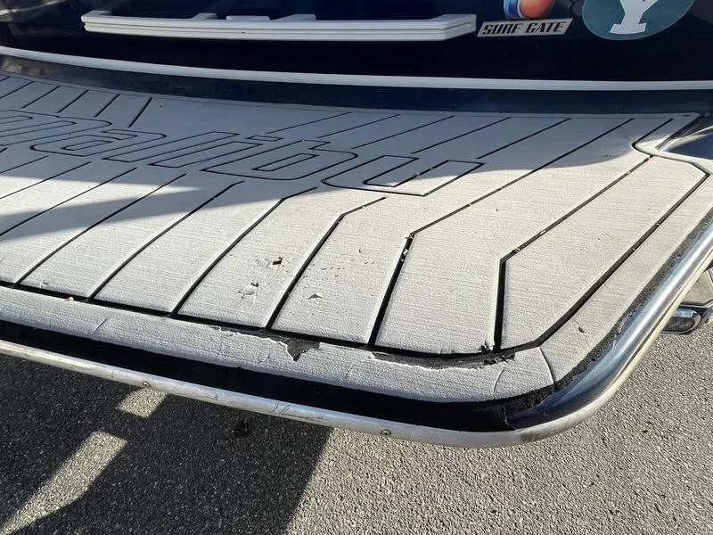 Slide: The Image of 2017 Malibu 21 VLX boat swim platform with visible wear and tear. - 40