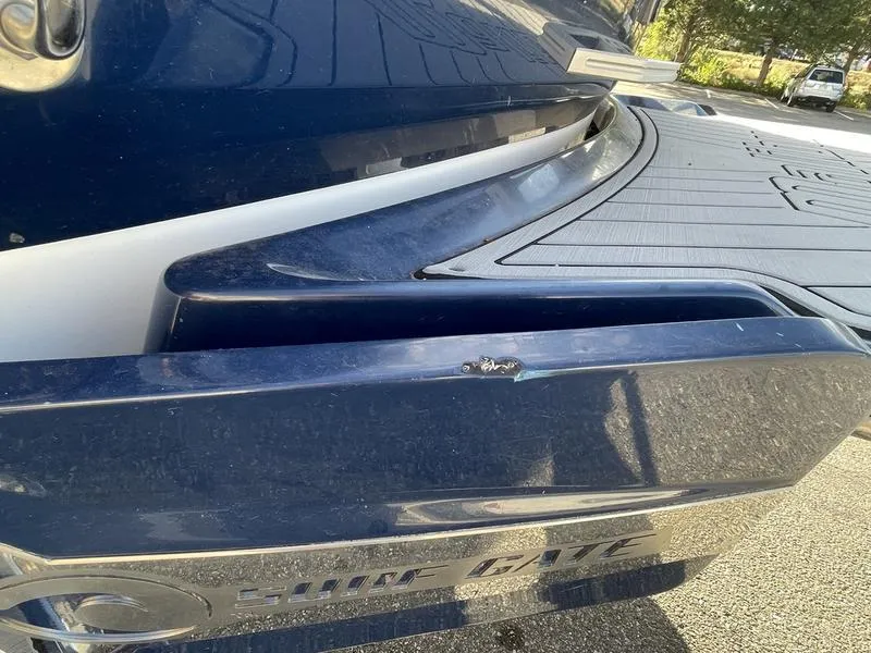 Slide: The Image of 2017 Malibu 21 VLX boat rear view with swim platform and blue finish. - 42