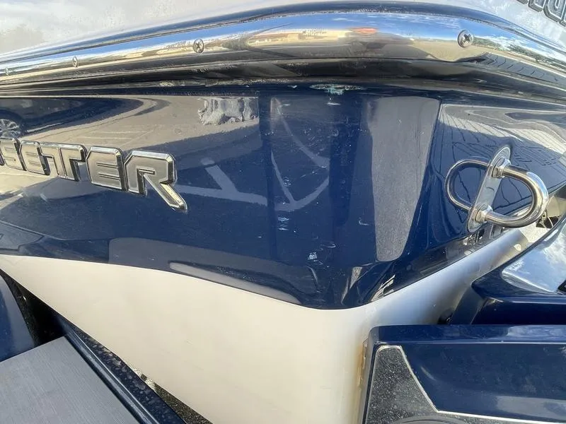 Slide: The Image of Close-up of 2017 Malibu 21 VLX boat exterior with blue and white finish. - 43