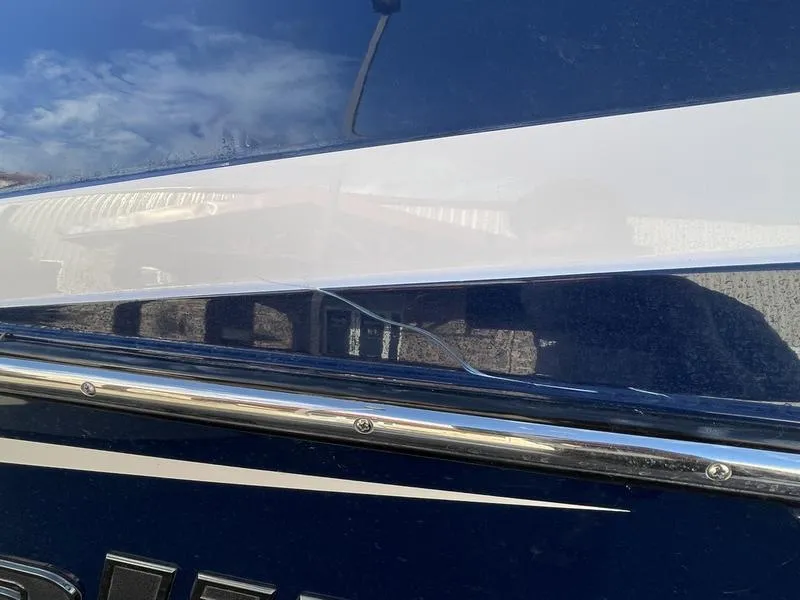 Slide: The Image of Close-up of a 2017 Malibu 21 VLX boat with visible surface crack. - 44