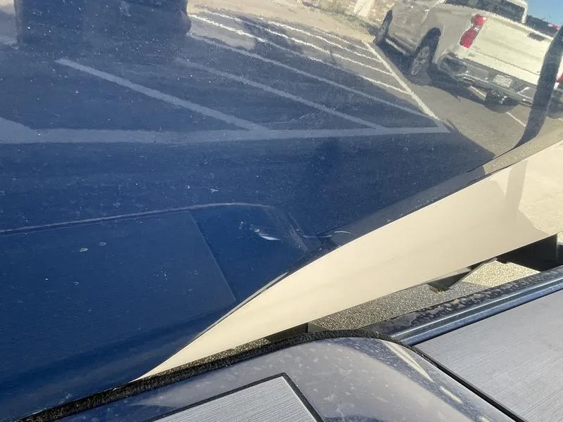 Slide: The Image of Close-up of a 2017 Malibu 21 VLX boat in a parking lot. - 46