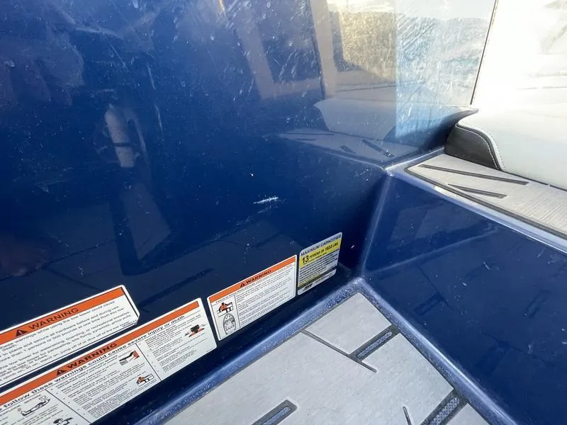 Slide: The Image of 2017 Malibu 21 VLX interior with safety labels and seating area. - 49