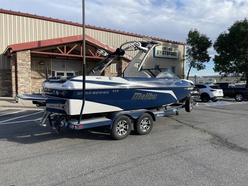 Slide: The Image of 2017 Malibu 21 VLX boat on trailer in parking lot. - 7