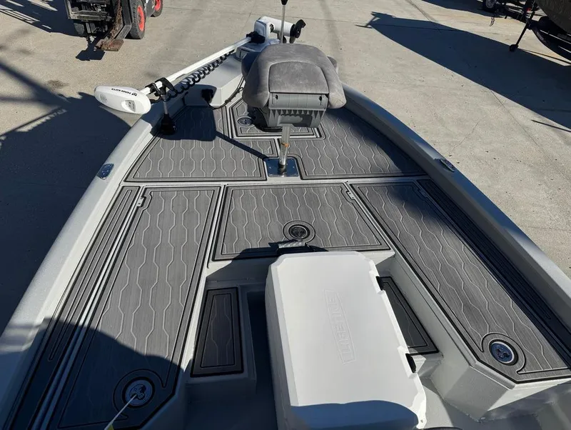 Slide: The Image of 2024 Avid 21 FS Platinum boat deck with gray textured flooring and seating. - 16