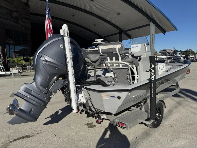 Slide: The Image of 2024 Avid 21 FS Platinum boat with Yamaha engine, parked outdoors. - 3