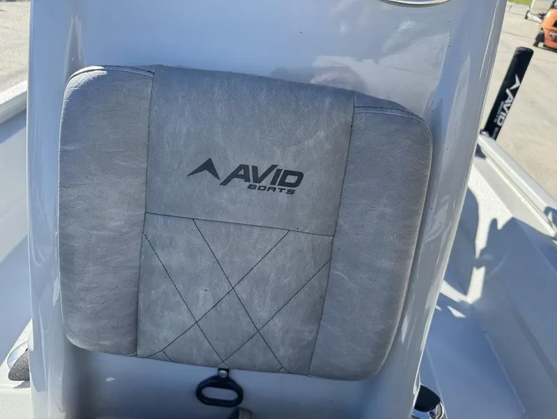 Slide: The Image of 2024 Avid 21 FS Platinum boat seat with logo, gray upholstery. - 9