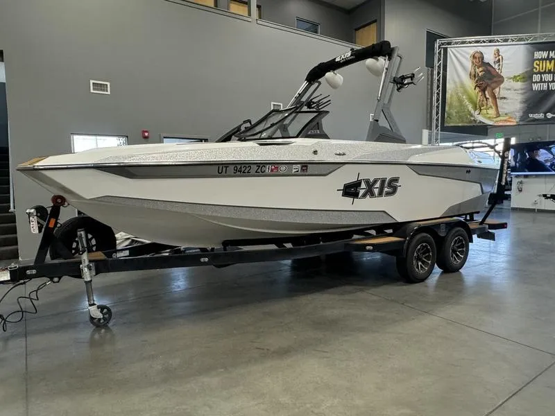 Slide: The Image of 2022 Axis A22 boat on trailer in showroom setting. - 3