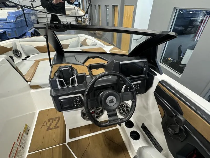 Slide: The Image of 2022 Axis A22 boat interior with modern dashboard and steering wheel. - 6