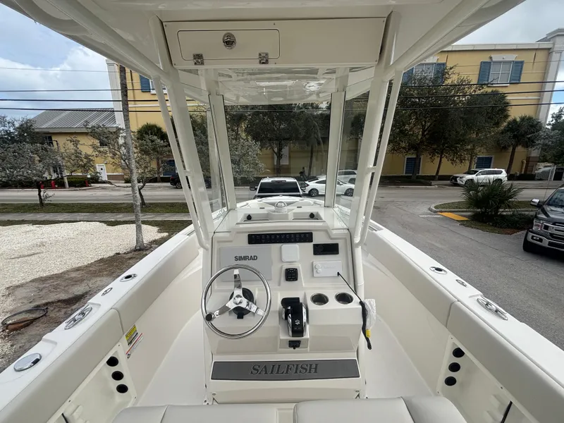 Slide: The Image of 2025 Sailfish 232 CC boat interior with steering console and controls. - 10