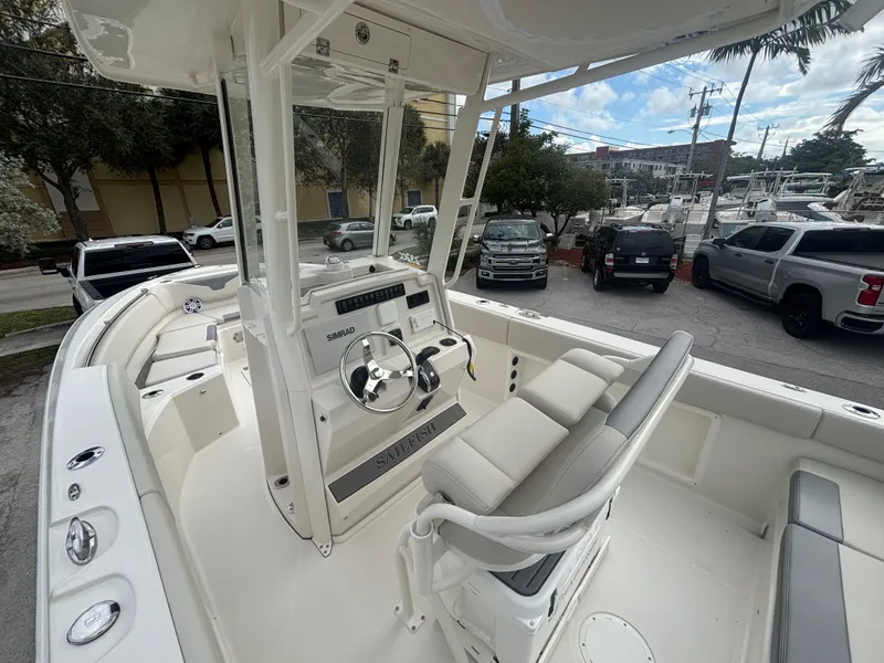 Slide: The Image of 2025 Sailfish 232 CC boat interior with steering console and seating. - 12