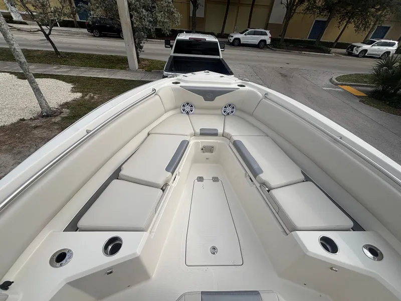 Slide: The Image of 2025 Sailfish 232 CC boat interior with cushioned seating and cup holders. - 16