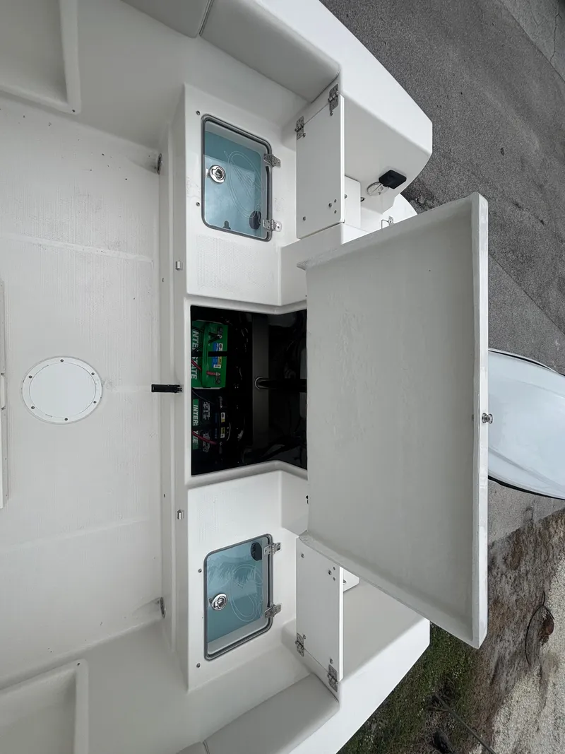 Slide: The Image of 2025 Sailfish 232 CC boat storage compartments and control panel. - 21