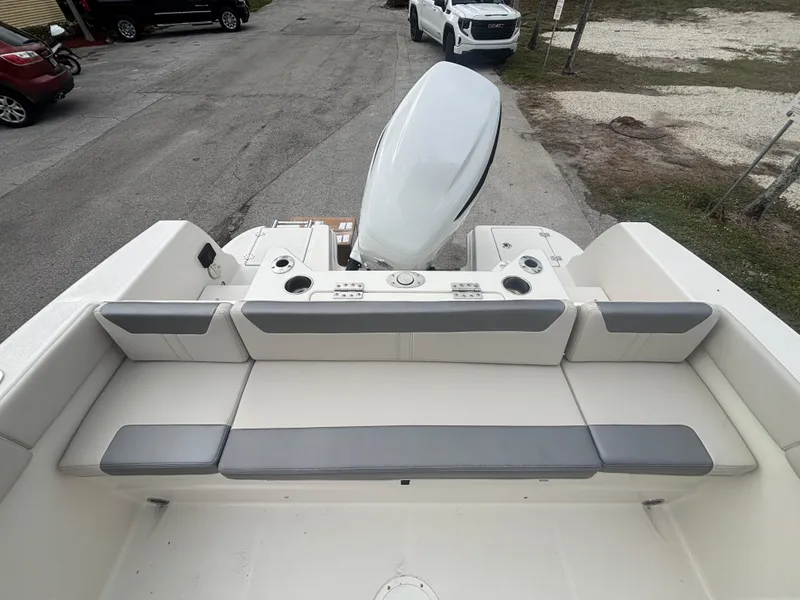 Slide: The Image of 2025 Sailfish 232 CC boat interior with cushioned seating and outboard motor. - 7