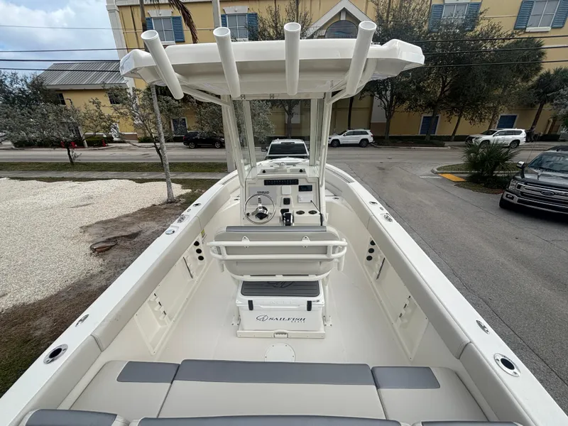 Slide: The Image of 2025 Sailfish 232 CC boat with center console and seating, parked outdoors. - 8