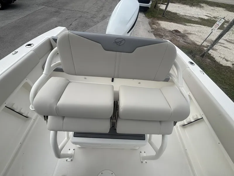Slide: The Image of 2025 Sailfish 232 CC boat with cushioned seating, white interior, and sleek design. - 9