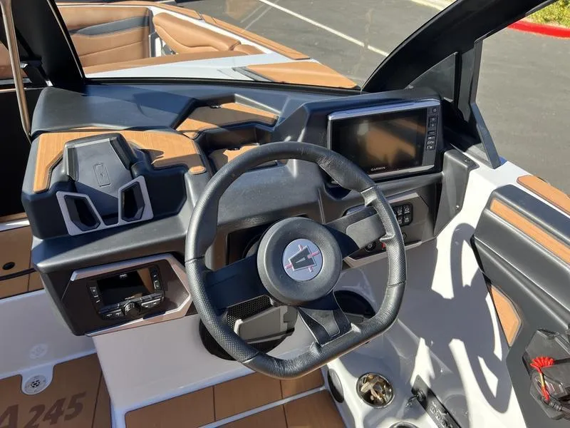 Slide: The Image of 2025 Axis A245 boat dashboard with steering wheel and digital display. - 11