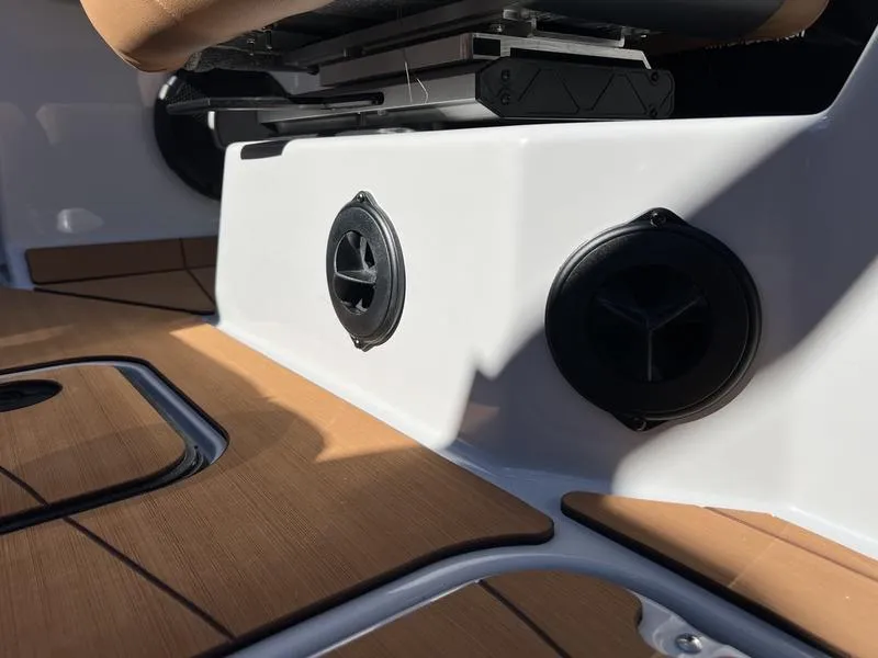 Slide: The Image of 2025 Axis A245 boat interior with speakers and wood accents. - 13