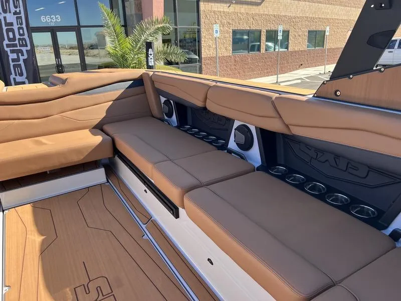 Slide: The Image of Luxurious interior of 2025 Axis A245 boat with tan seating and cup holders. - 16