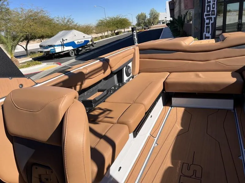 Slide: The Image of 2025 Axis A245 boat interior with tan leather seating and wood flooring. - 18