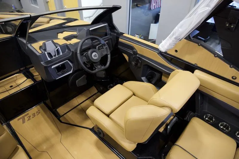 Slide: The Image of Luxurious interior of 2025 Axis T235 boat with tan leather seats and modern dashboard. - 10