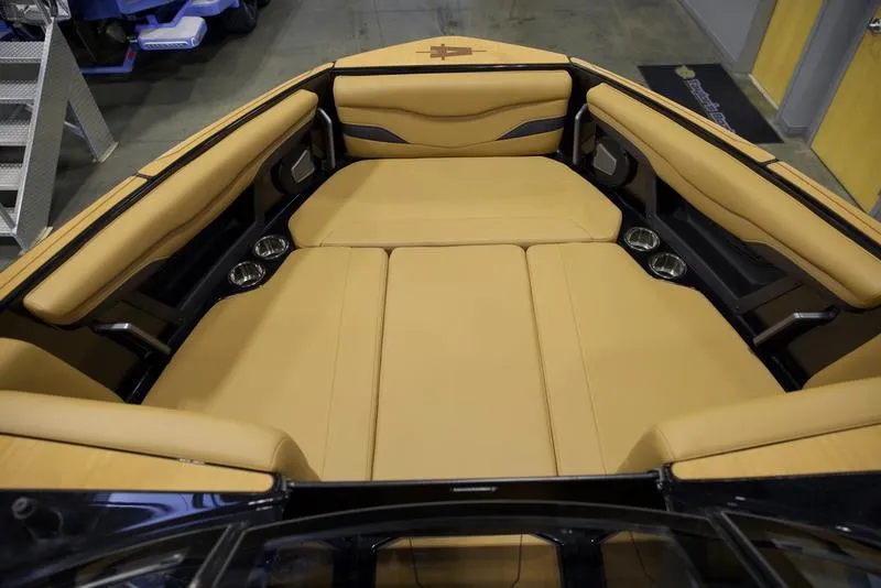 Slide: The Image of Luxurious tan seating in 2025 Axis T235 boat interior with cup holders. - 13