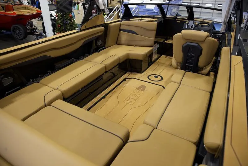 Slide: The Image of Luxurious interior of 2025 Axis T235 boat with tan leather seating. - 14
