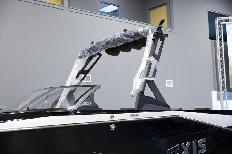 Slide: The Image of 2025 Axis T235 boat with sleek design and modern features in showroom. - 7