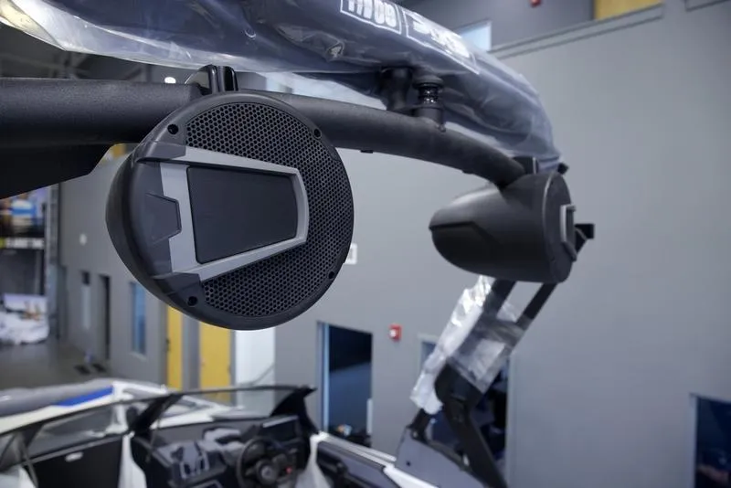 Slide: The Image of 2025 Axis A245 boat with mounted speakers in a showroom. - 10