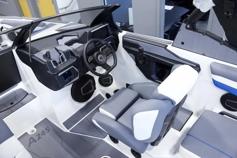 Slide: The Image of 2025 Axis A245 boat interior with modern steering and seating design. - 11