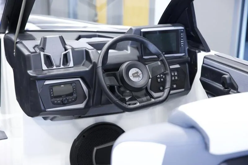 Slide: The Image of 2025 Axis A245 boat dashboard with modern controls and steering wheel. - 12