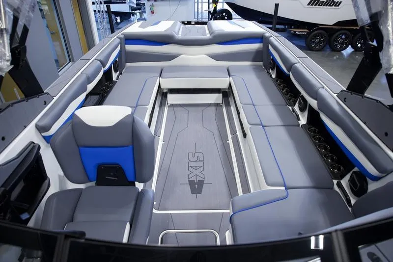 Slide: The Image of 2025 Axis A245 boat interior with gray and blue seating, spacious layout. - 19
