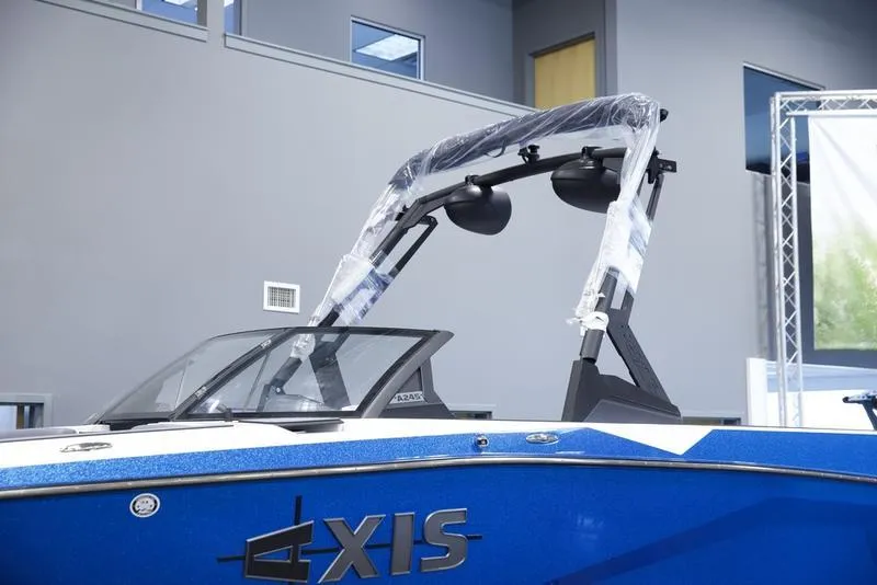 Slide: The Image of 2025 Axis A245 boat with blue exterior and sleek design in showroom. - 7
