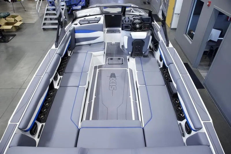 Slide: The Image of 2025 Axis A245 boat interior with spacious seating and modern dashboard. - 9