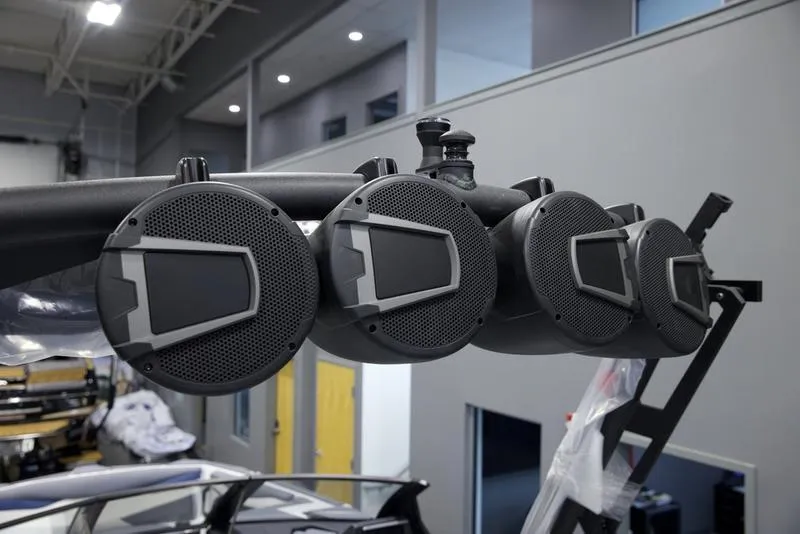 Slide: The Image of Axis A245 2025 boat speakers in a modern showroom setting. - 10
