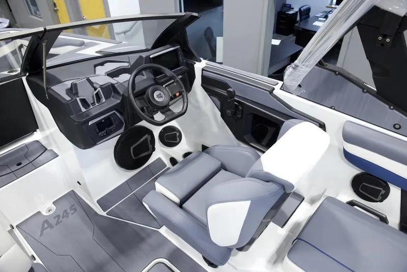Slide: The Image of Interior of 2025 Axis A245 boat, featuring modern steering and seating. - 11