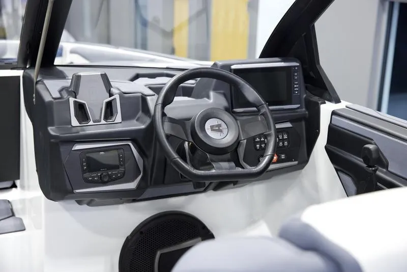 Slide: The Image of 2025 Axis A245 boat dashboard with modern steering wheel and digital displays. - 12