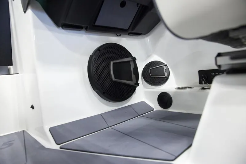 Slide: The Image of 2025 Axis A245 boat interior with speakers and seating area. - 13