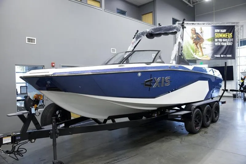 Slide: The Image of 2025 Axis A245 boat on trailer in showroom. - 3