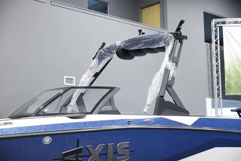Slide: The Image of 2025 Axis A245 boat with sleek design and protective wrap in showroom. - 7