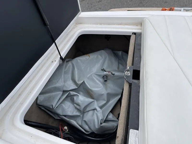 Slide: The Image of Storage compartment of 2001 MasterCraft X30 boat with cover and wiring. - 14