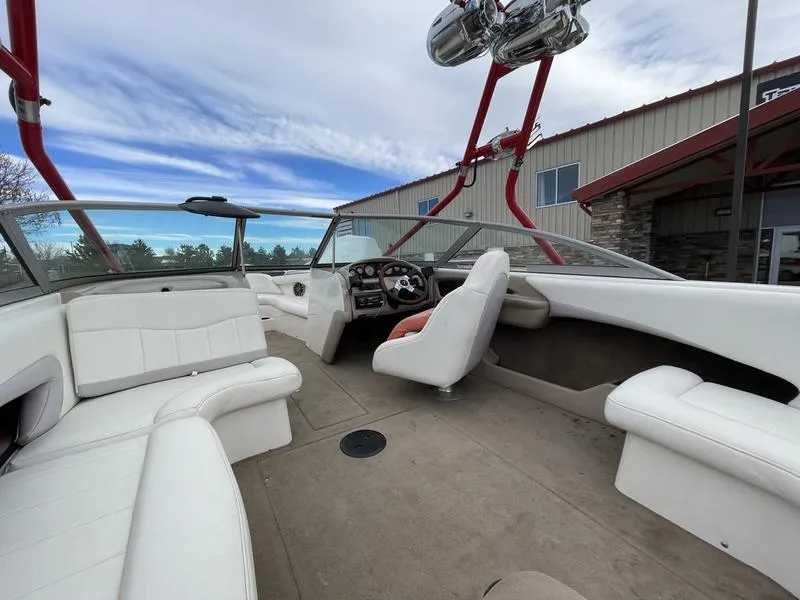 Slide: The Image of 2001 MasterCraft X30 boat interior with white seating and red accents. - 15