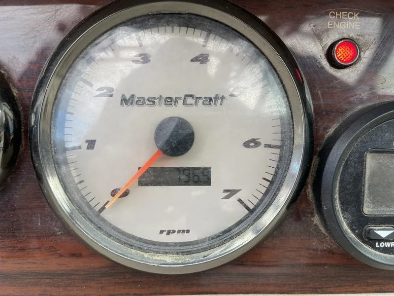 Slide: The Image of Close-up of 2001 MasterCraft X30 RPM gauge with check engine light. - 17